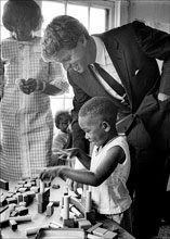 past Robert Kennedy with young school child 1967. Photo by Jim Lucas